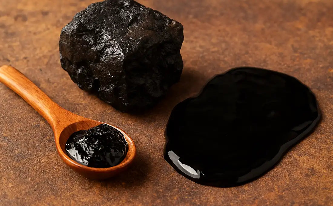 Shilajit on a wooden table with a spoon